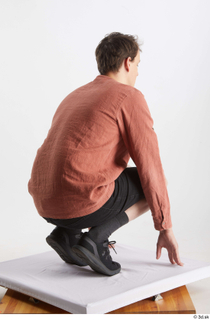  Brett  1 black jeans shorts black sneakers casual dressed kneeling orange linen shirt whole body 0006.jpg
